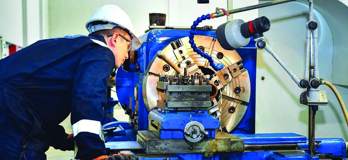 Drill & Cut machinist operating a lathe in the workshop
