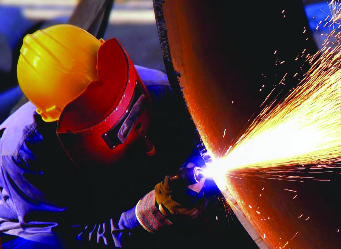 Technician carrying out industrial repair work with sparks
